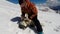 Man playing with husky dog in snow