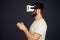 Man is playing on a joystick using virtual reality glasses