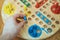 Man playing Ludo board game.