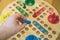 Man playing Ludo board game.