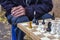 man playing old chess in late autumn, front and background blurred with bokeh effect