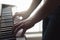 Man playing piano standing in home studio.