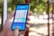 Man playing sudoku game on smartphone outdoors, closeup