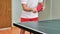 Man playing table tennis with robot automatic feed balls system
