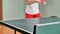 Man playing table tennis with robot automatic feed balls system