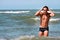 Man playing with water to the sea. Water droplets in flight.