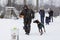 A man plays with a Doberman in the winter, editorial