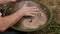 A man plays the Hang - a modern percussion musical instrument, music for relaxation and meditation. Close-up. Ethnic