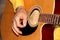 Man plays a six-stringed wooden guitar, musical concept, close-up