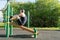 A man plays sports on the site, does exercises to strengthen the press using an inclined bench