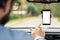 Man pointing on blank smartphone screen in car windshield holder