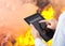 Man pointing at insurance wording on tablet with fire