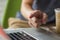 Man pointing at a laptop screen, closeup, soft blured background