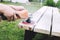 man polishes the board on the bench. man repairing bench