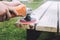 Man polishes the board on the bench. man repairing bench