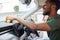 Man Polishing And Cleaning Dashboard Of Car During Car Valet