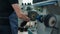 Man polishing leather shoes on manufacture with machinery