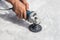 Man polishing marble table by angle grinder