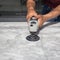 Man polishing marble table by angle grinder