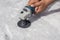 Man polishing marble table by angle grinder