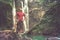 Man in pool at the base of large waterfall