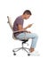 Man with poor posture using smartphone while sitting in armchair