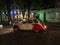 Man pops out of a Citroen to take a photo of a Paris street at night