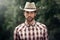Man, portrait and outdoor cowboy clothes, western culture and countryside ranch in Texas. Male person, hat and flannel