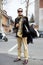 Man poses for photographers with elegant velvet jacket before Gucci fashion show, Milan Fashion Week Day 1