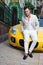 Man posing with convertible sportcar