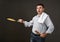 Man posing with a pancake in a pan, white shirt and pants, gray background, surprised emotions