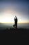 Man posing yoga on top of misty mountain cliff