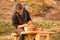 Man potter work with clay ware. Young man potter on his workshop with nature background