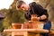 Man potter work with clay ware. Young man potter on his workshop with nature background