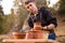 Man potter work with clay ware. Young man potter on his workshop with nature background