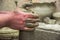 Man potter at work creating some traditional cups of white clay, Lassithi, Crete, Greece.