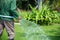 Man pouring grass with the water tap