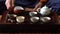 Man Pouring Puer Tea in Teapot at Traditional Chinese Tea Ceremony. Set of Equipment for Drinking Tea