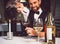 Man pouring scarlet wine in glass