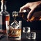 Man pouring whiskey into a glass with ice cubes