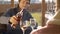 Man pouring wine into the glasses outdoors