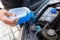 Man pours anti-freeze fluid into his car