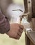 A man pours beer into a glass with a wooden barrel