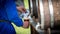 A man pours beer into a glass with a wooden barrel