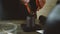 a man pours coffee beans into a manual coffee grinder