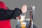 Man pours draft beer in plastic glass during picnic. Close up isolated image with no face. Tap of movable bar counter with hands