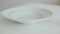 Man pours flakes in a white bowl