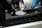 Man pours metal powder into the chamber of a laser sintering machine