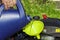 A man pours oil on his lawn mower