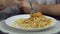 A man pours spaghetti with ketchup and eats them, accelerated shooting